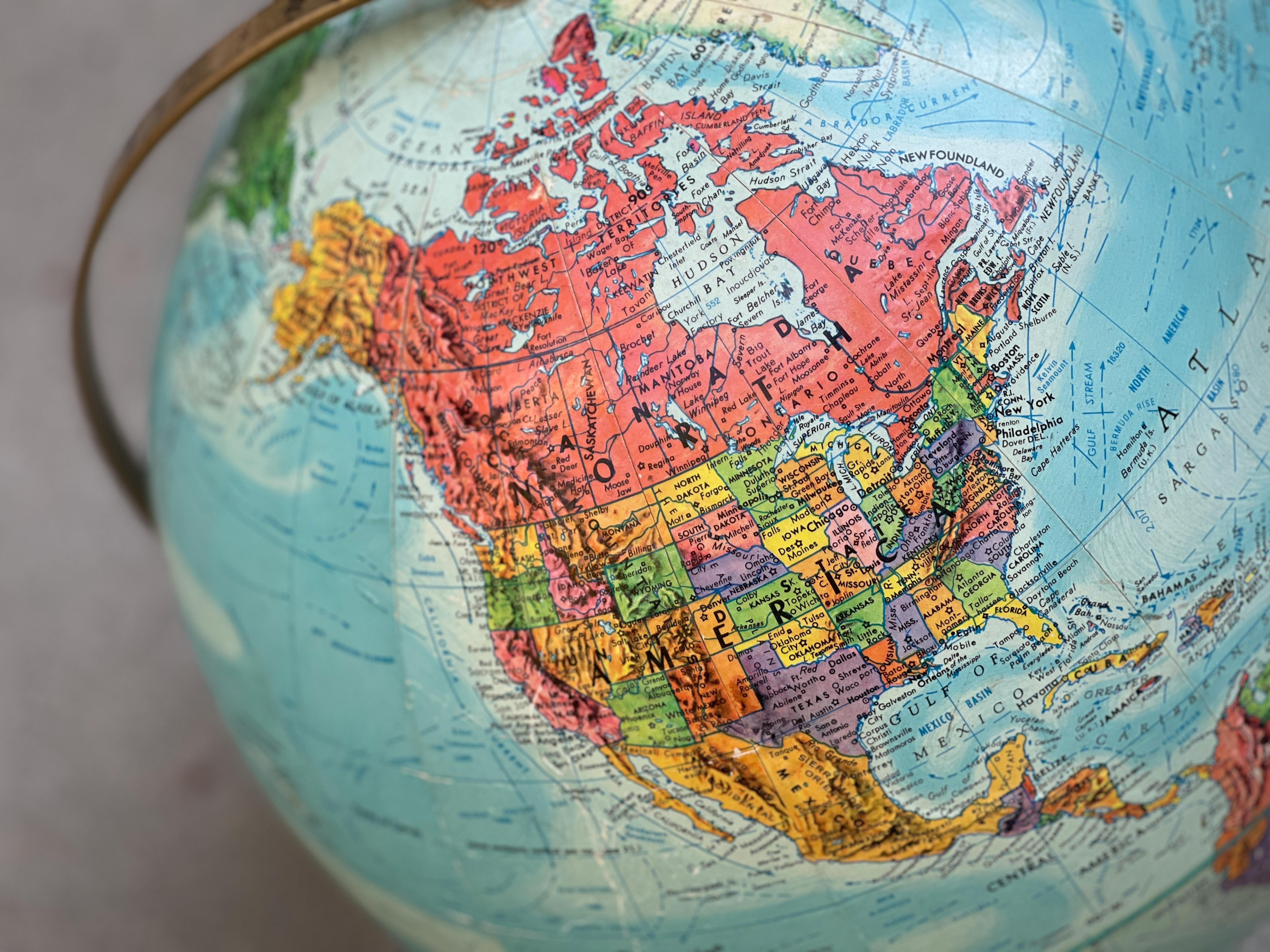 Detailed close-up of a vintage globe highlighting North America with vivid colors.